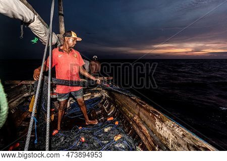 Dar Es Salaam, Tanzania - March 2023: Local Fishermen Are In The Process Of Fishing On An Old Boat.