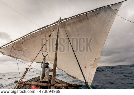 Dar Es Salaam, Tanzania - March 2023: Local Fishermen Are In The Process Of Fishing On An Old Boat.