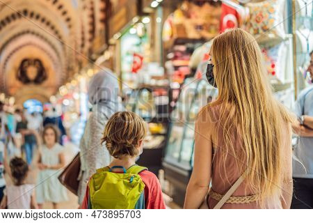 Mother And Son Tourists Walks Among The Countless Shops At The Grand Bazaar And Egyptian Bazaar In I