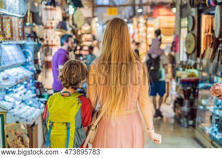 Mother And Son Tourists Walks Among The Countless Shops At The Grand Bazaar And Egyptian Bazaar In I