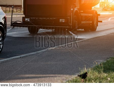 Street Flusher Machine On The Road With Streams Of Water Up