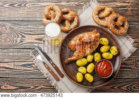 Grilled Half Chicken With Boiled Potatoes And Tomato Sauce Served With Beer And Pretzel Closeup On T