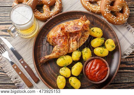 Traditional Bavarian Dish Roast Half Chicken With Boiled Potatoes And Tomato Sauce Served With Beer 