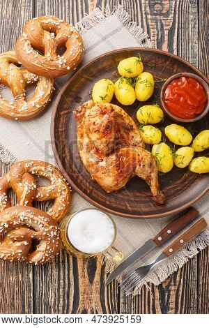 Oktoberfest Roast Chicken Wiesn Hendl With Potatoes Served With Beer And Pretzel Closeup On The Wood