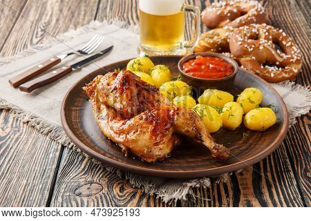 Grilled Half Chicken With Boiled Potatoes And Tomato Sauce Served With Beer And Pretzel Closeup On T