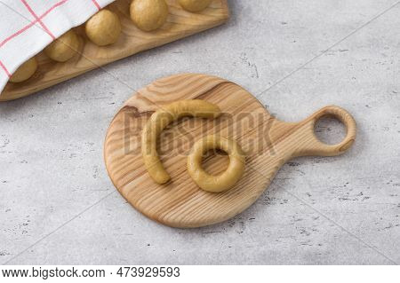 Raw Dough Pieces For Greek Easter Cookies With Sesame Seeds On A Gray Textured Background. Step By S