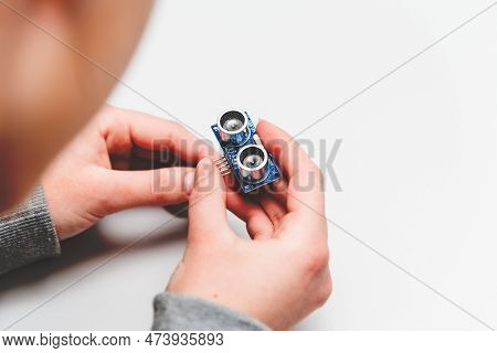 Student Girl Learning To Program Robot Ultrasonic Distance Sensors Facing Arduino Nano Board. Stem P