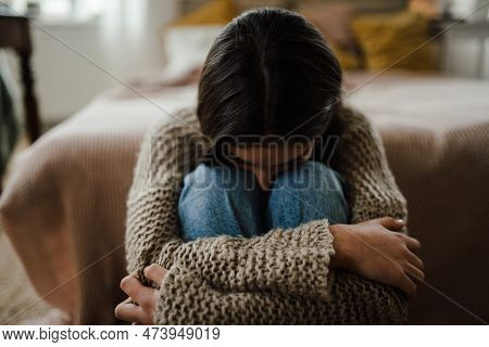 Teenage Girl Sitting On The Floor With Head On Her Knees, Koncept Of Mental Health.