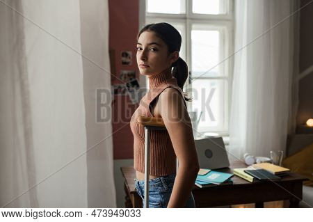 Unhappy Girl With Broken Leg In Her Room Looking Trough Window