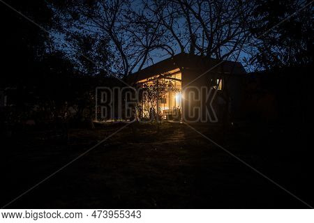 Old House With A Ghost In The Forest At Night Or Abandoned Haunted Horror House In Fog. Old Mystic B