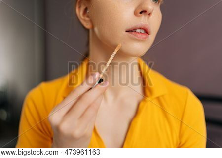 Close-up Cropped Shot Of Young Woman With Natural Beauty Applying Foundation On Face To Correct Skin