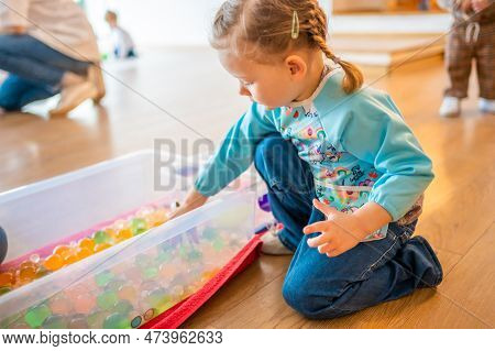 Little Girl Playing With Sensory Water Beads, Hydrogel Balls. Sensory Development And Experiences, T