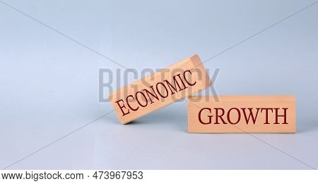 Economic Growth Text On The Wooden Block, Blue Background