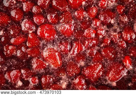 Process Of Making Homemade Strawberry Jam. Red Sweet Syrup Boiling On The Stove Closeup. Strawberry 