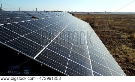Solar Power Plant. Flight Over Modules Of Solar Power Station On Sunny Day. Alternative Green Electr