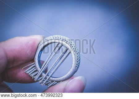 Man Is Holding Object Printed On Metal 3d Printer. Object Printed In Laser Sintering Machine. Modern