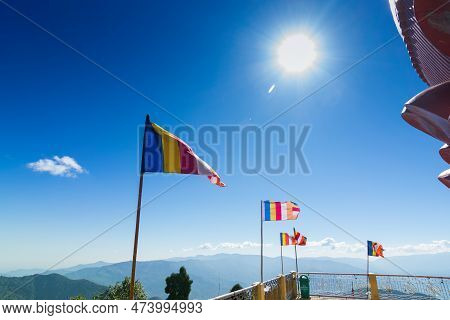 Colourful Buddhist Prayer Flags Are Waving In Strong Wind Under Sunshine At Samdruptse, Huge Buddhis
