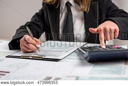 Woman Working With Business Report Document , Filling Tax Form, Accounting