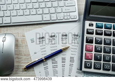 1040 Tax Forms With Pen And Computer Keyboard On Table