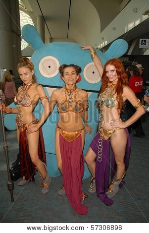 Paula Labaredas, Alicia Arden and Phoebe Price at the annual Slave Leia Group Photo at ComicCon, San Diego Convention Center, San Diego, CA. 07-23-10