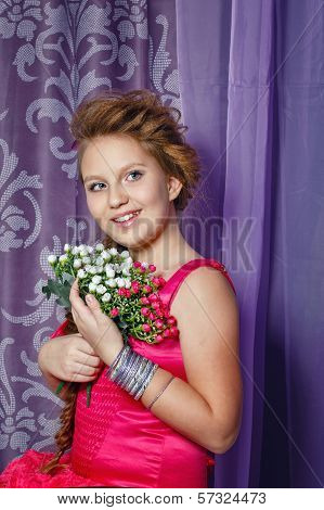 Little Girl In Pink Dress With Bouquet Of Flowers