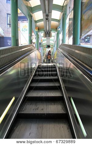 HONG KONG ISLAND, CHINA - DECEMBER 30 2013 : People using the Centra Mid-Levels escalator in Hong Kong on December 30, 2013. It is the longest outdoor covered escalator system in the world.