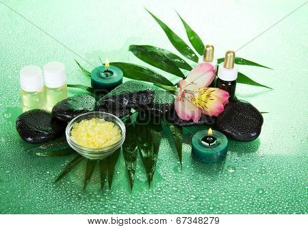 Candles, aroma oil, salt, stones and flower