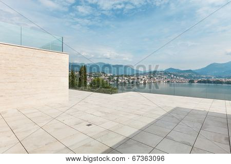 beautiful terrace of a modern penthouse, lake view 