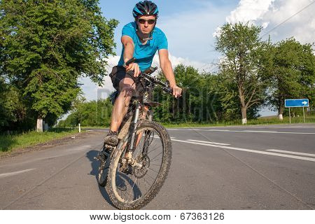 Man Cycling At The Road