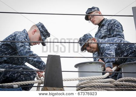 STATEN ISLAND, NY - MAY 21: Sailors aboard the guided-missile destroyer USS McFaul (DDG 074) tend the lines as the ship docks at Sullivans Piers during Fleet Week NY on May 21, 2014.