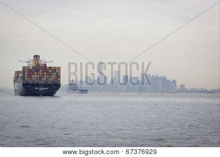 STATEN ISLAND, NY - MAY 21: USS Oak Hill (LDS 051) sails past a cargo ship on the Hudson River near Lower Manhattan before docking at Pier 92 in New York for Fleet Week NY on May 21, 2014.