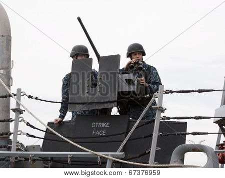STATEN ISLAND, NY - MAY 21: Sailors stand watch aboard the guided-missile destroyer USS Cole (DDG 067) at Sullivans Piers during Fleet Week NY on May 21, 2014.