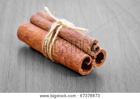 Cinnamon Sticks On Grey Wooden Background