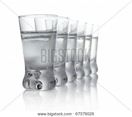 Many Glasses Of Vodka Isolated On White Background