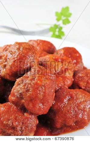 closeup of a plate with a spanish meatballs stew on a set table