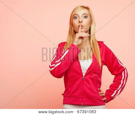 Secret Woman. Fitness Girl Showing Hand Silence Sign