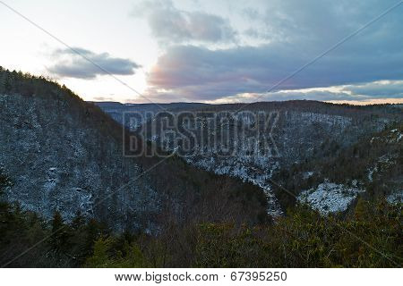 Spruce trees on black hills before the dark falls