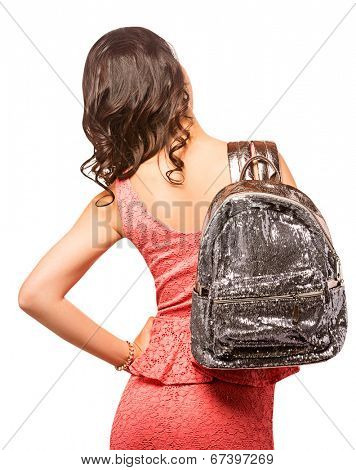 Closeup of woman with sequin silver backpack. Wearing pink mini lace dress. Isolated on the white studio background.