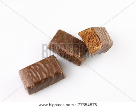 Bitten Chocolate Candy On A White Background.