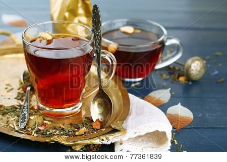 Beautiful vintage composition with herbal tea, on wooden table