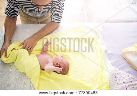 Dad dressing up his baby