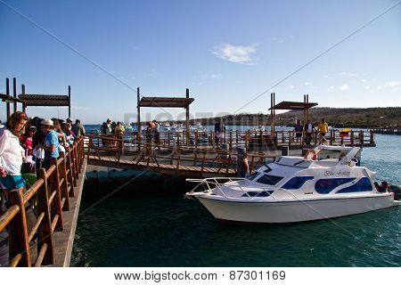 Unidentified tourists in the port of San Cristobal island, Galapagos