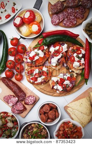 Tapas, antipasto or meze, mediterranean cold buffet food isolated on white background