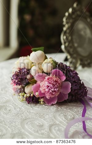 Wedding spring violet bouquet of bride on table
