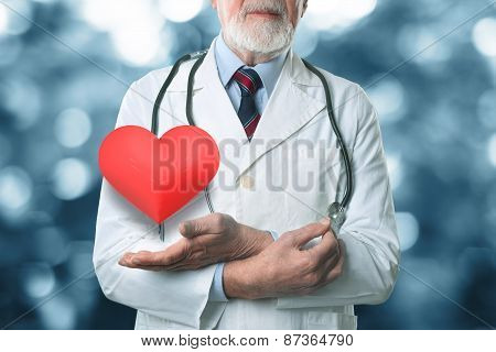 Female doctor holding a beautiful red heart shape