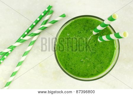 Green smoothie downward view on granite