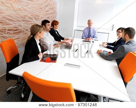 business people group on meeting at modern bright office indoors. Senior  businessman as leader in discussion.