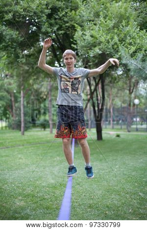 Almaty, Kazakhstan - 04,07,2013: slacklining in the park in the evening