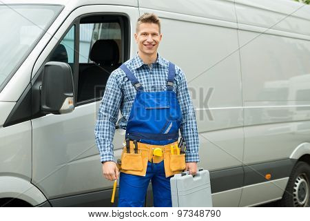 Repairman With Tools And Toolbox In Front Of Van