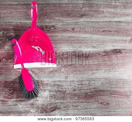 Small Whisk Broom And Dustpan On Wooden Floor